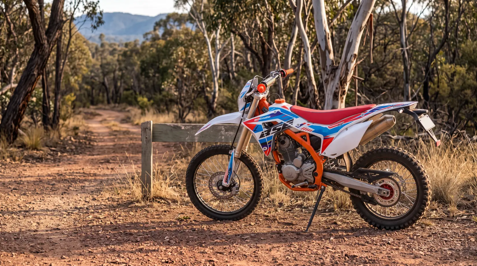 Dirt bike parked at a trailhead sign in Australian bushland